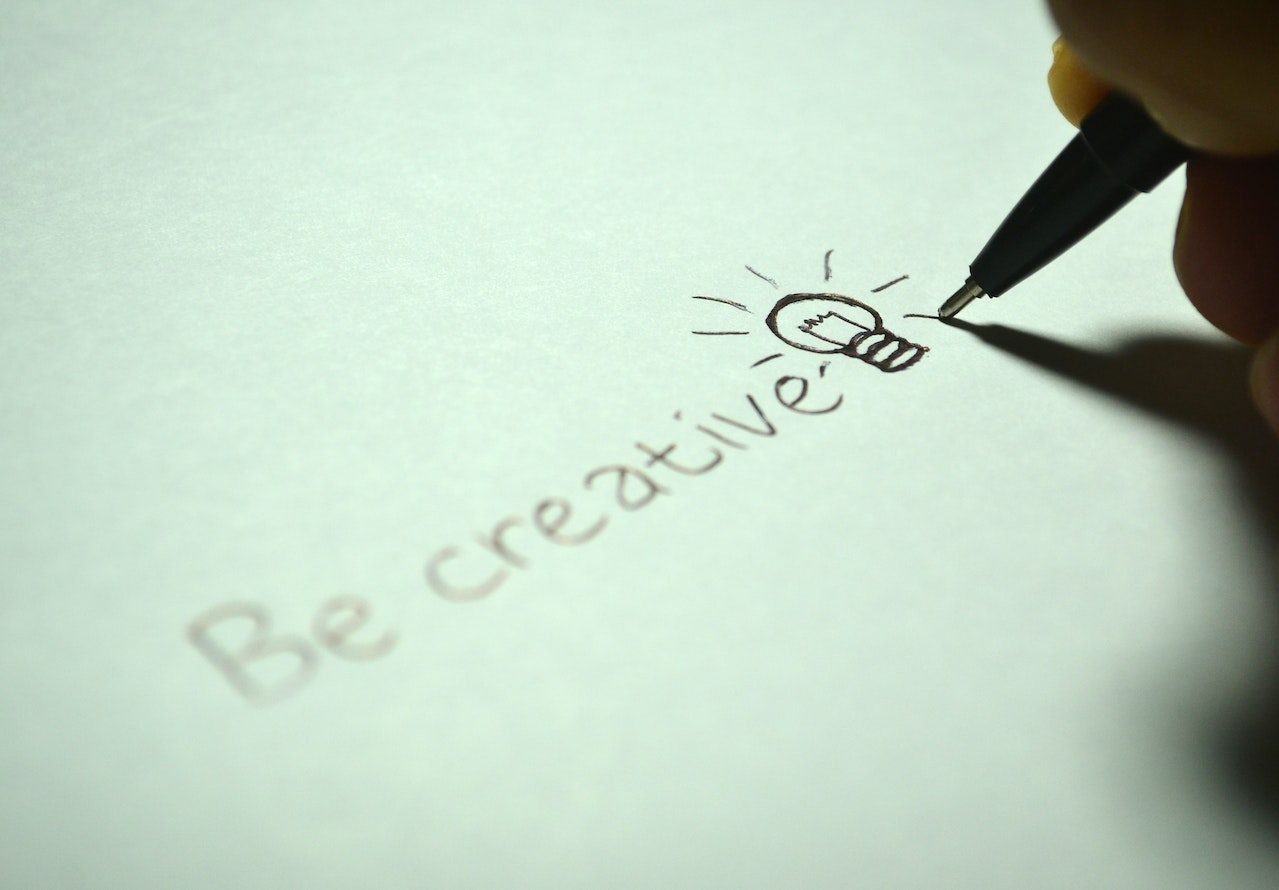 Note on a paper that says 'Be creative'.